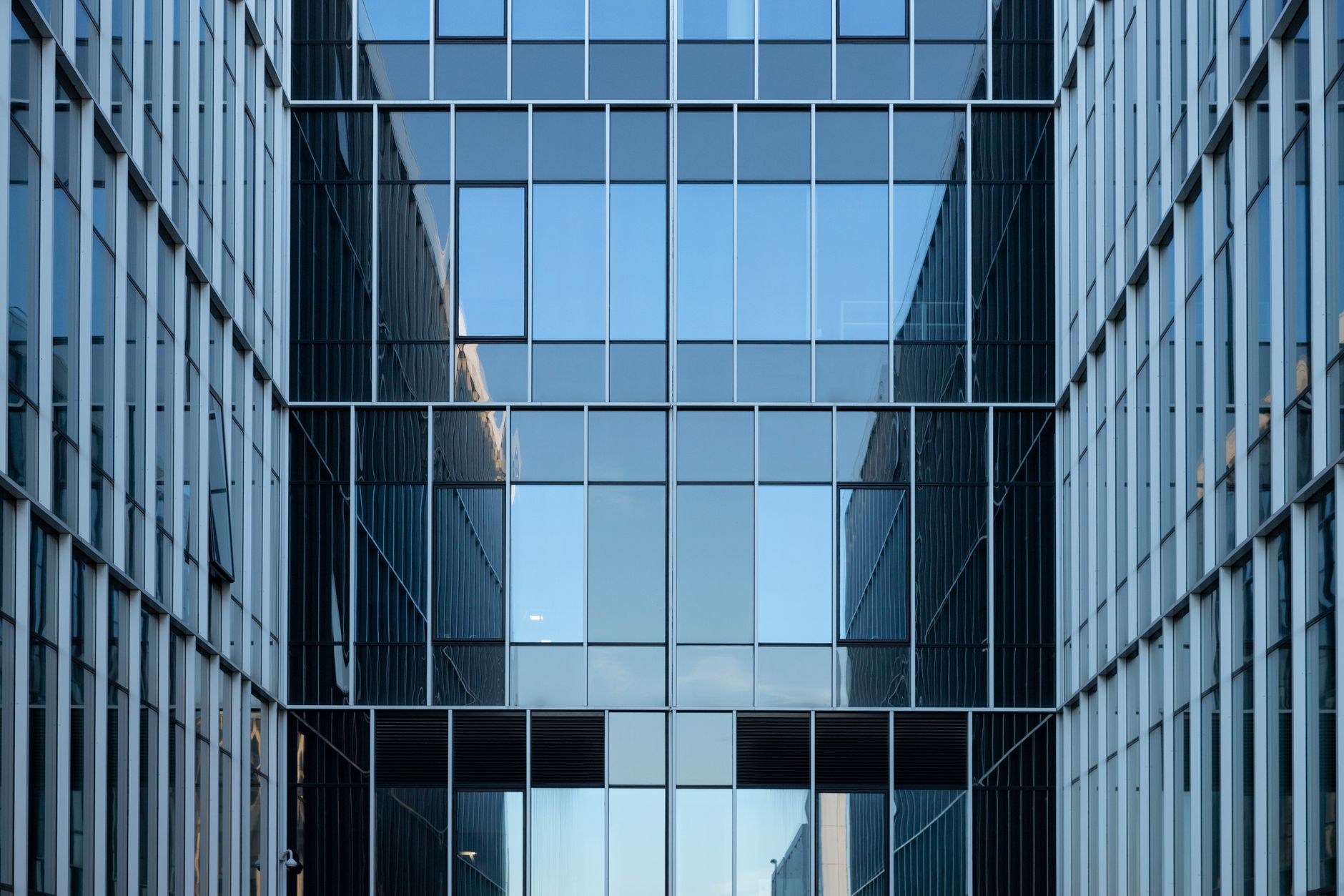 Reflective glass facade of a modern corporate office tower.